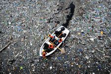 boat travelling through plastic pollution