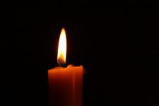 lit candle on a black background