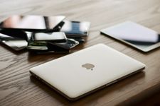phones piled up next to a MacBook